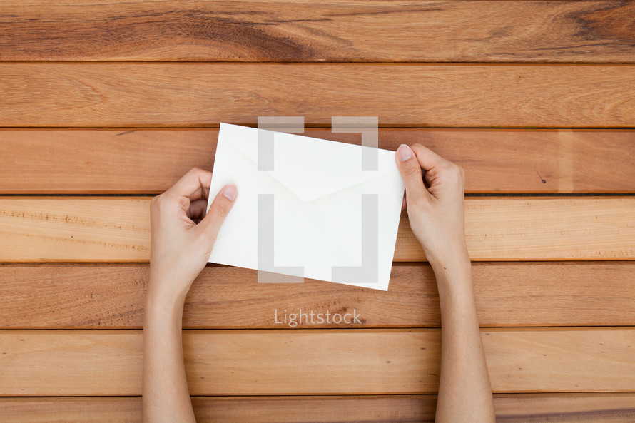 hands holding an envelope 