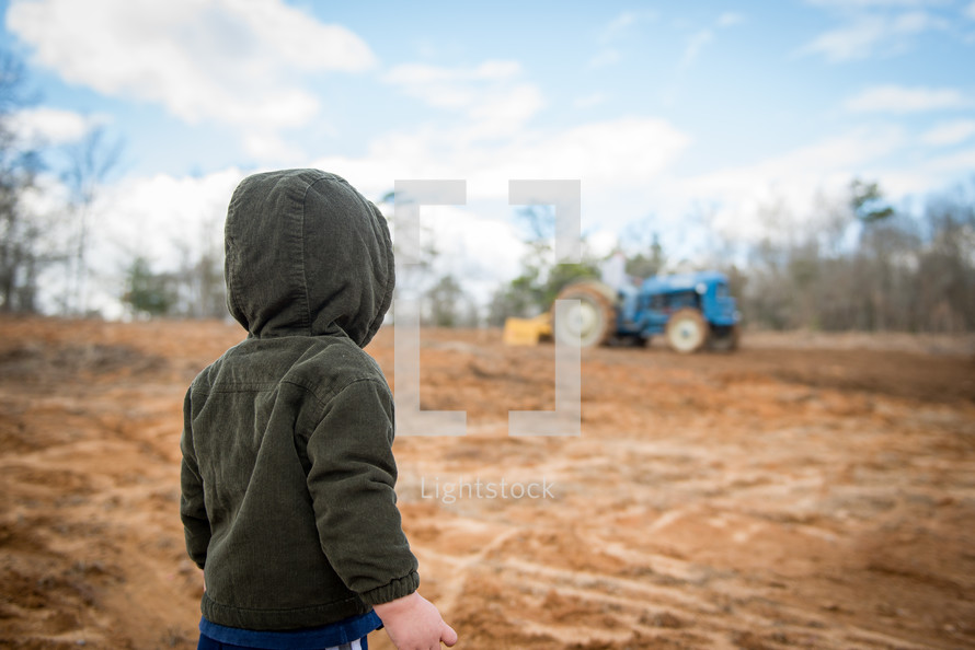a boy child and a tractor 