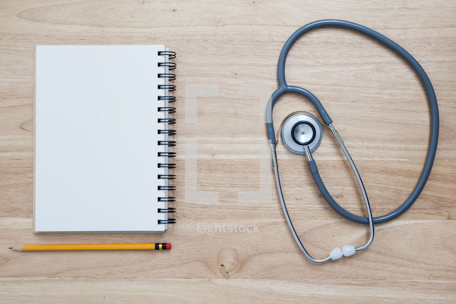 pencil, notebook, and stethoscope 