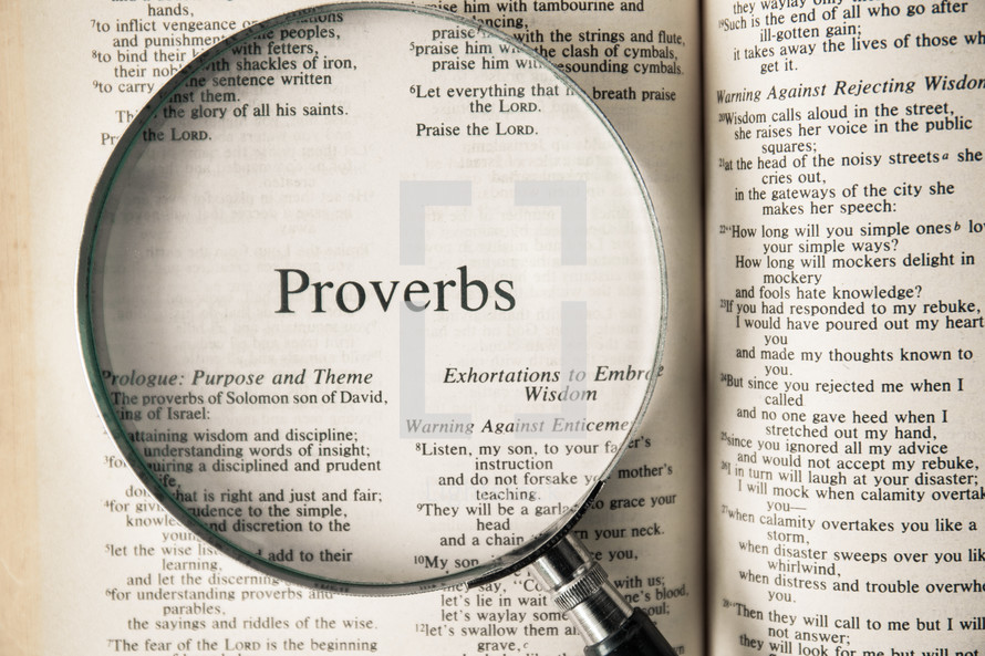 magnifying glass over Bible - Proverbs 