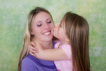 daughter kissing her mother on the cheek