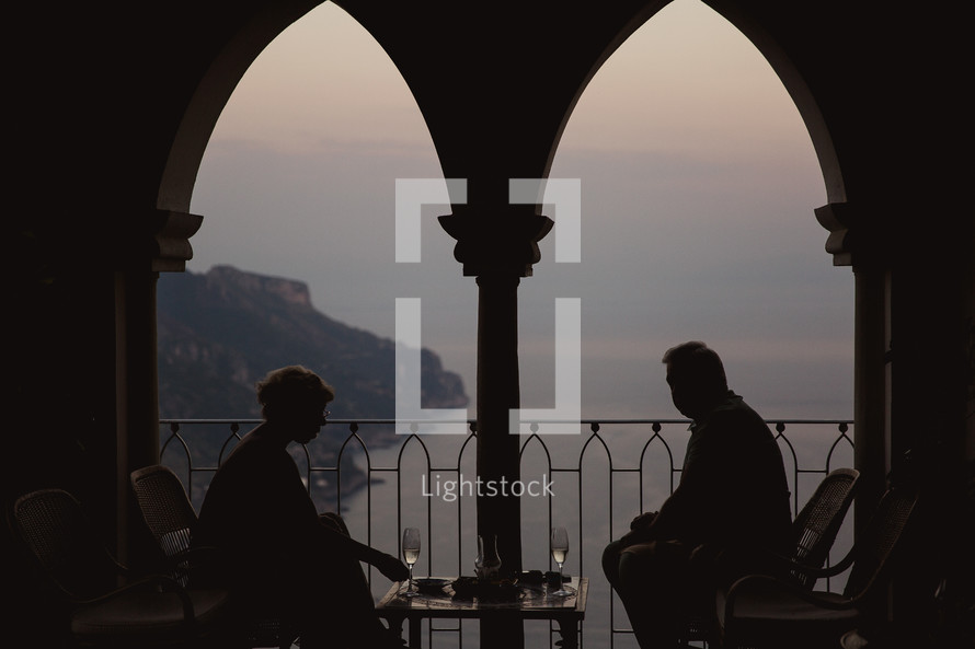 a couple having dinner on a balcony in Italy 