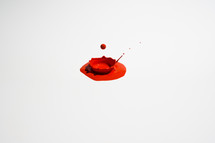dripping red paint on white background 