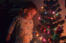 Child next to Christmas Tree