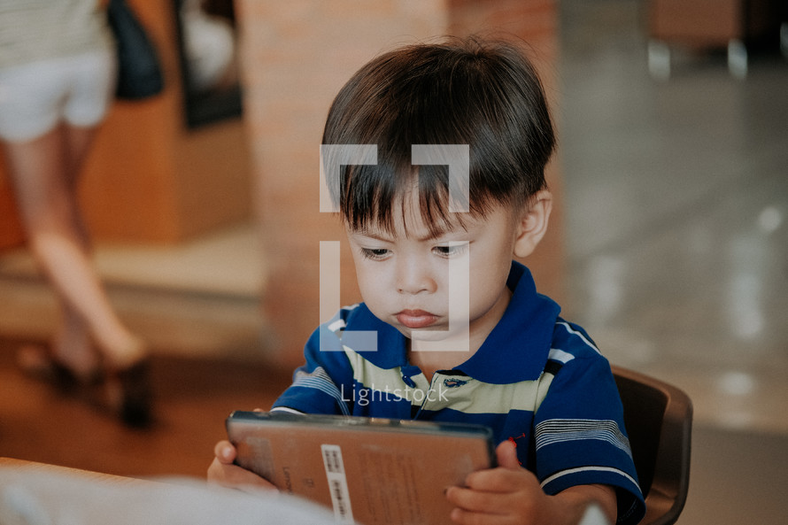 a toddler holding a book 