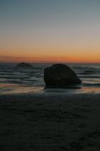 rocks on a shore at sunset 
