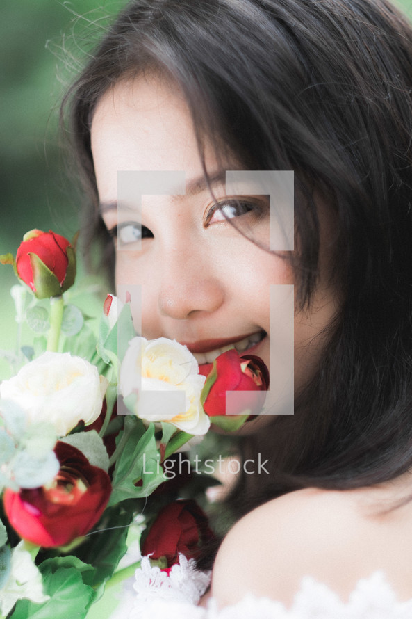 girl holding red and white roses 