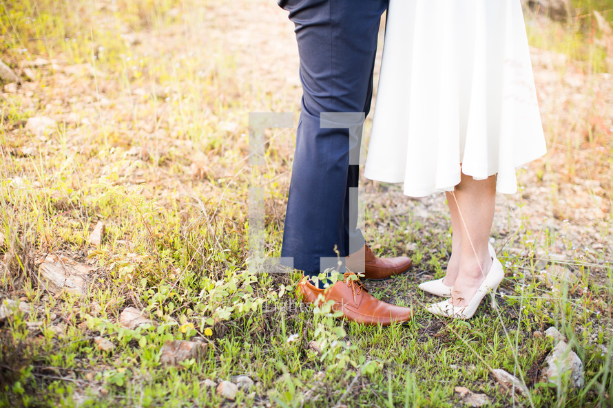 legs of a bride and groom 