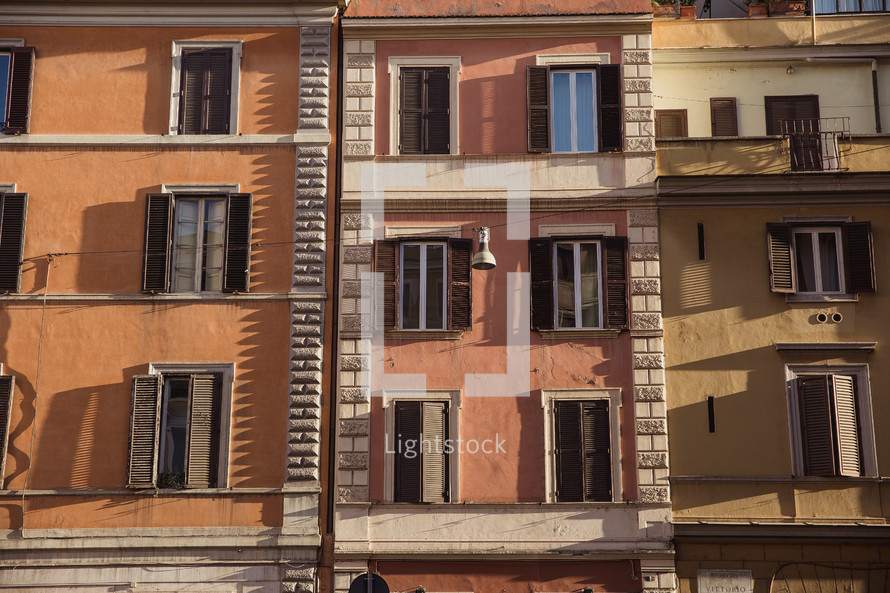windows on the side of a building in Rome 