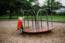 toddler boy on a playground 