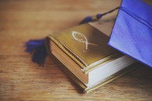 a mortar board and Bible