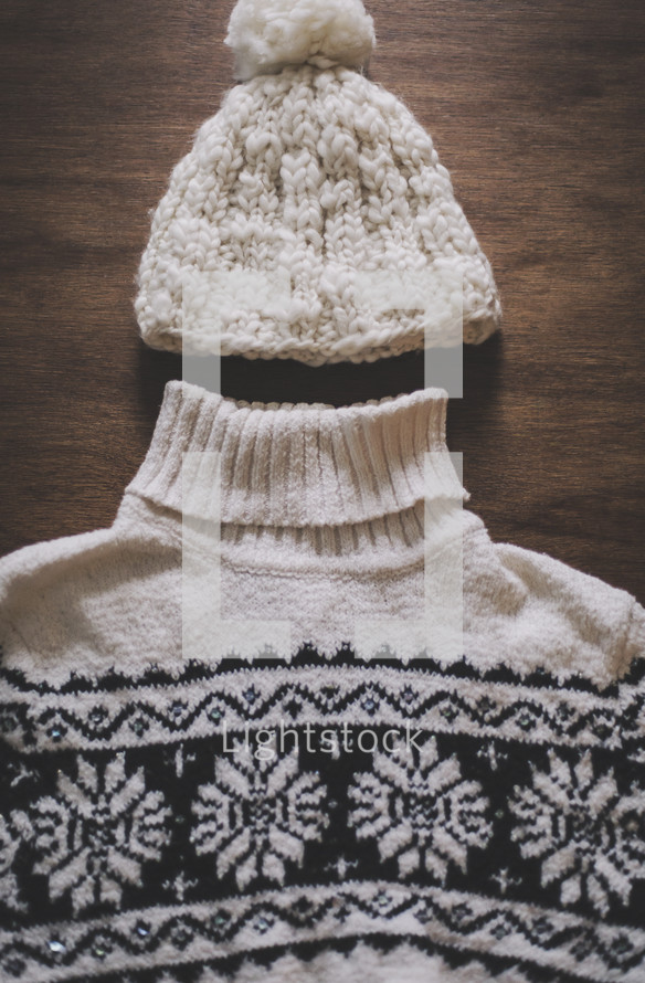 a winter sweater and knit hat