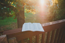 open Bible on a railing 