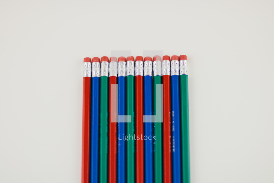 row of pencil erasers on a white background 