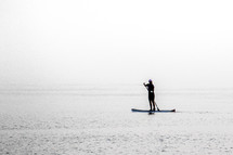 a woman on a paddle board 
