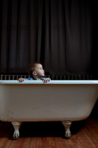 a boy in a bathtub 