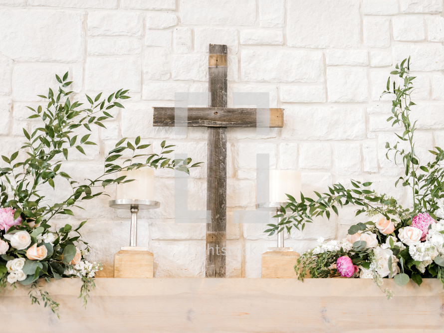 cross and flowers on an altar at a wedding 
