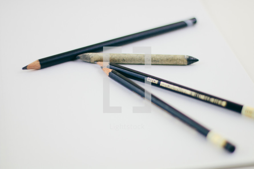 black pencils on a white background 