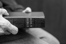 elderly man holding a Bible 