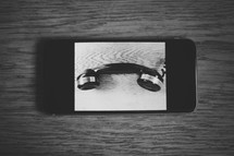 a capture of an iPhone with photo of a vintage phone