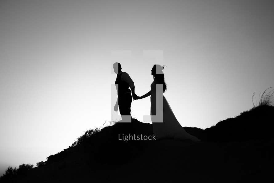 Silhouettes of a couple walking
