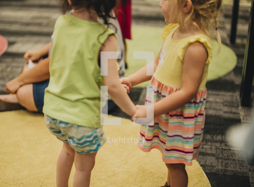 toddler girls holding hands 