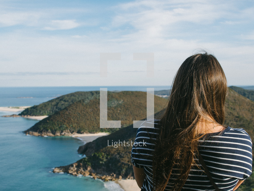 a woman standing at the top of a cliff overlooking Nelson Bay 