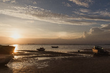 boats along a shore in the Bahamas at sunset 