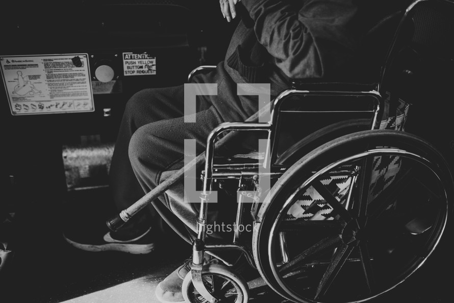 a man in a wheelchair on a city bus 