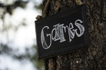 Games sign on a tree 