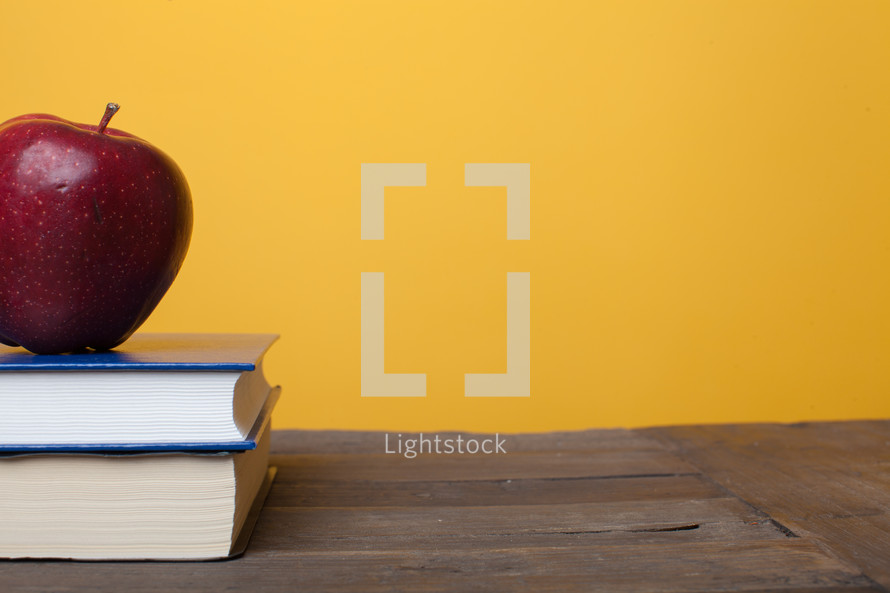 apple on a stack of books 