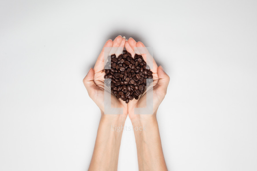 coffee beans in cupped hands 