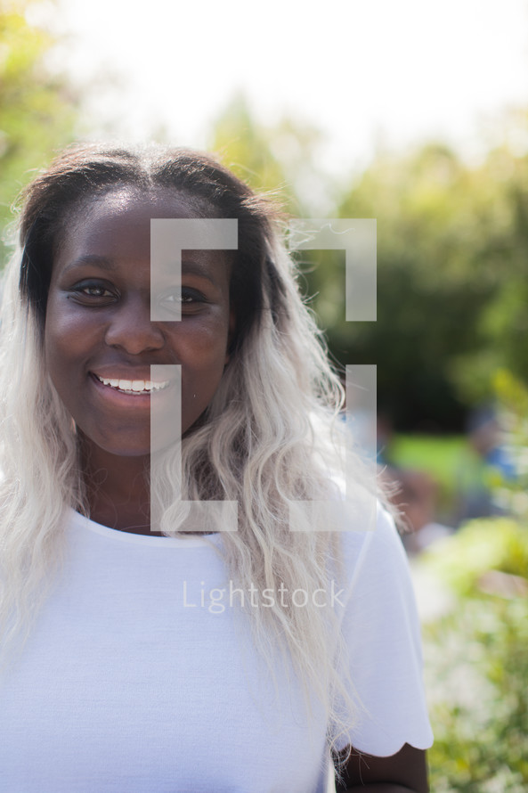 headshot of an African American young woman at a backyard party 