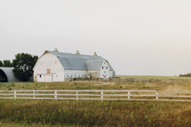 a white barn on a farm 
