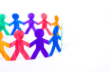 rainbow of paper dolls holding hands in a circle
