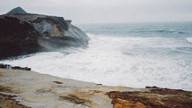 waves in the ocean along a rocky shore 