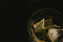 a glass jar stuffed with dollar bills
