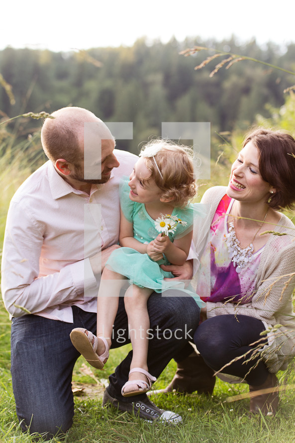 a family picking flowers in a meadow 
