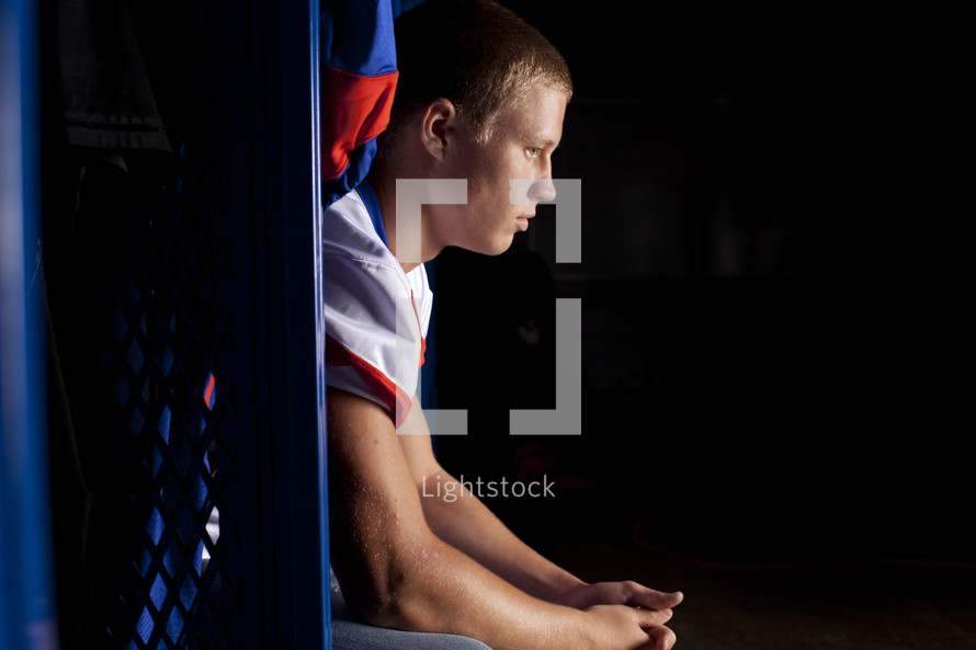 football player praying before a game 