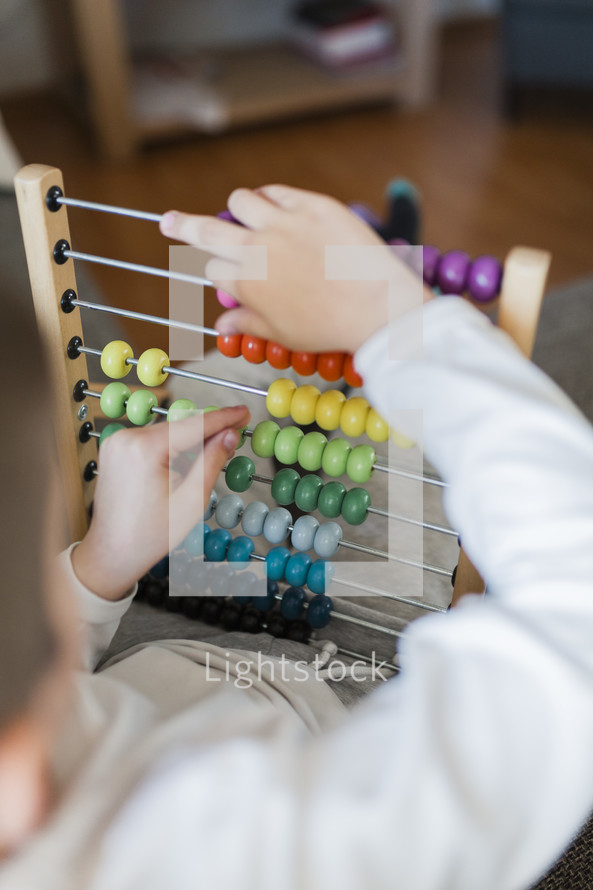 Boy Counting On An Abacus