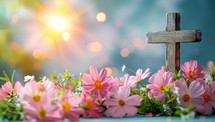 Wooden cross with flowers and bokeh on blue background.