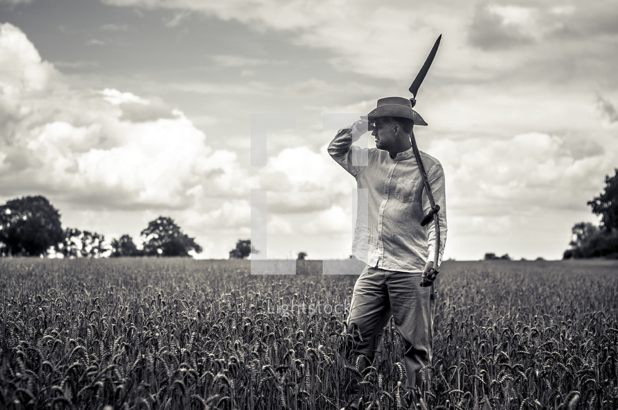 a man with a blade in a wheat field 