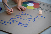A child painting a Happy Birthday sign 
