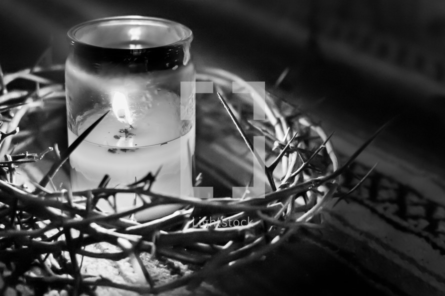 crown of thorns around a candle 