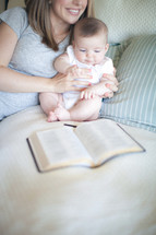 mother and baby and an open Bible