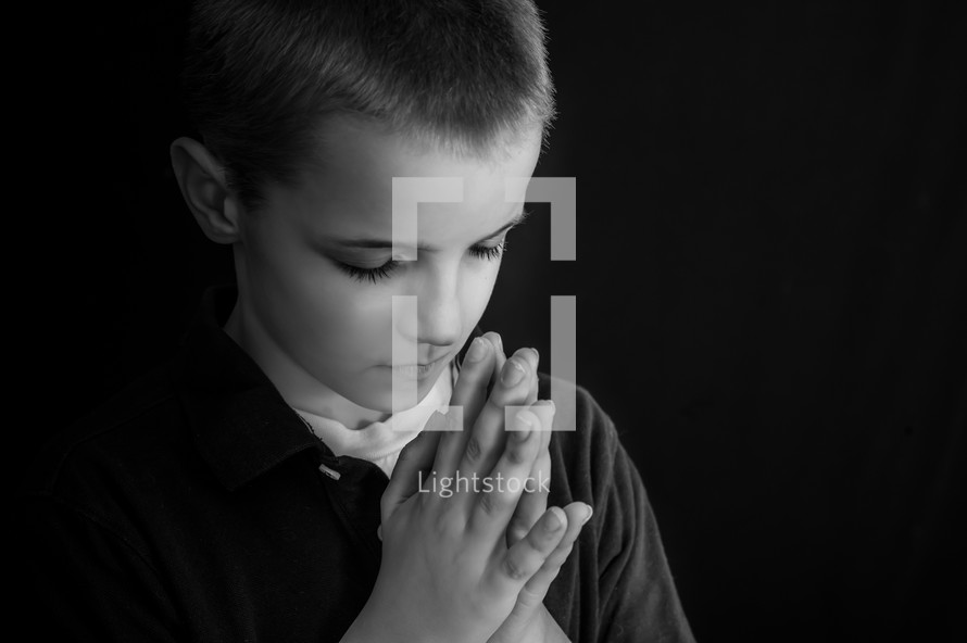 A boy child in prayer 