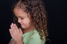 A girl child praying 