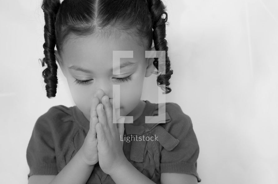 toddler in prayer