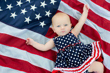infant girl on an American flag 
