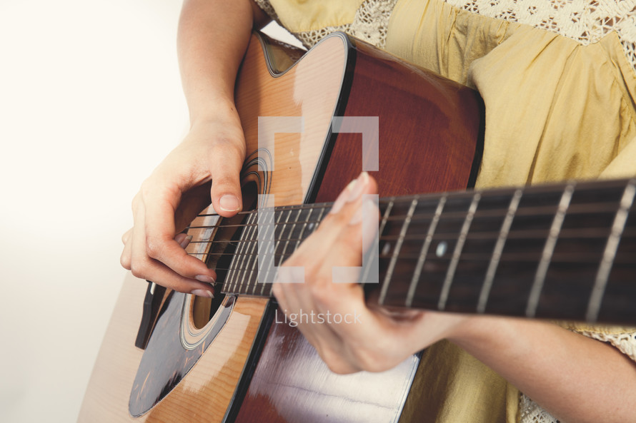 woman playing a guitar 